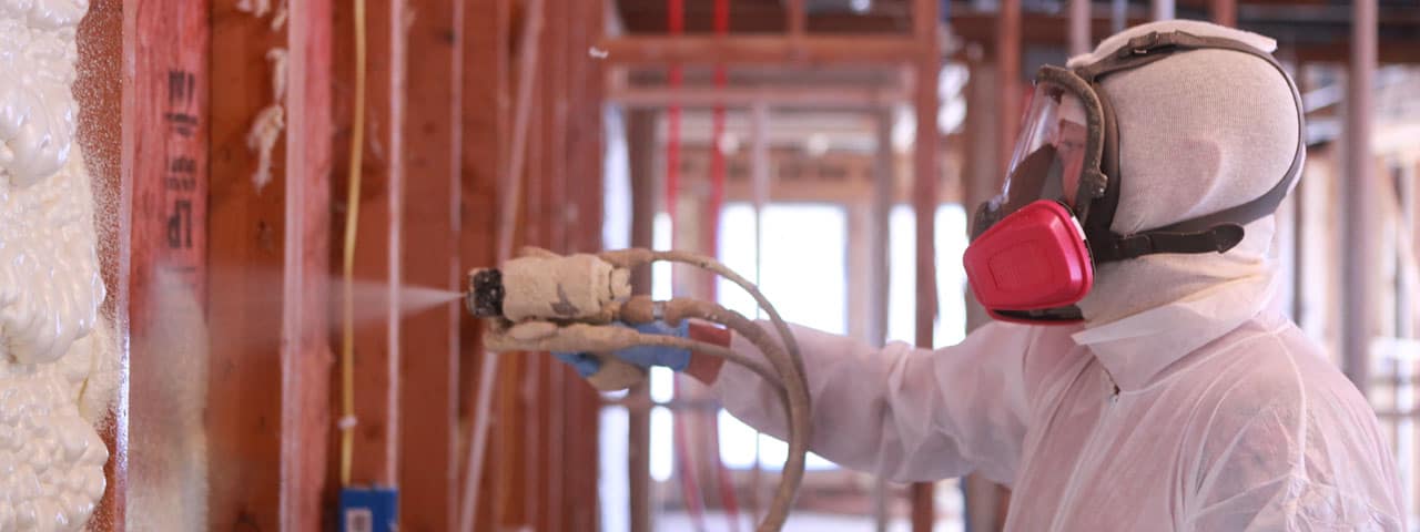 Closeup of closed-cell spray foam insulation being applied in a Kansas City home
